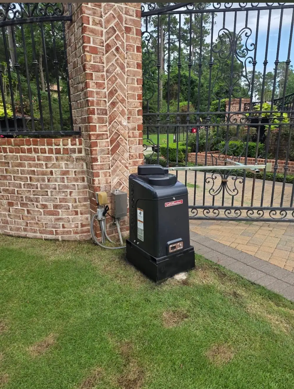 LiftMaster swing gate operator installed by Texas Gates on ornamental iron estate gate